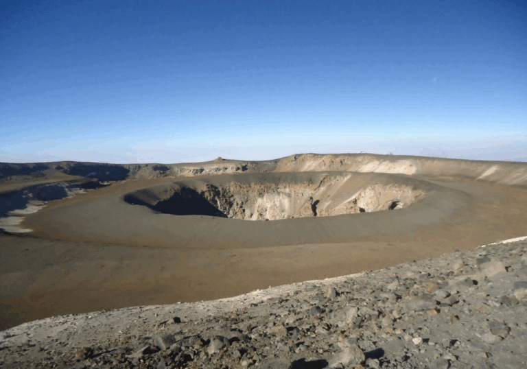 Dry, snowless crater rim of Mount Kilimanjaro showing volcanic rock and summit trail | Kili Quests