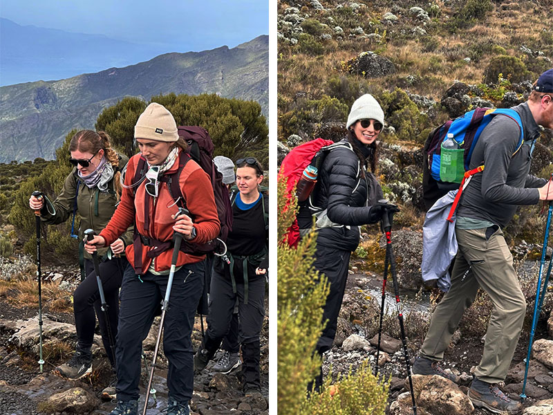 Happy tourist walking along a high-altitude trail on Kilimanjaro with a smile and trekking gear | Kili Quests