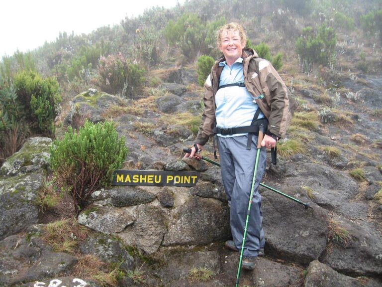 A woman standing quietly at Masheu Point near Whona on Mount Kilimanjaro, a sacred place where Chagga ancestors performed rain rituals