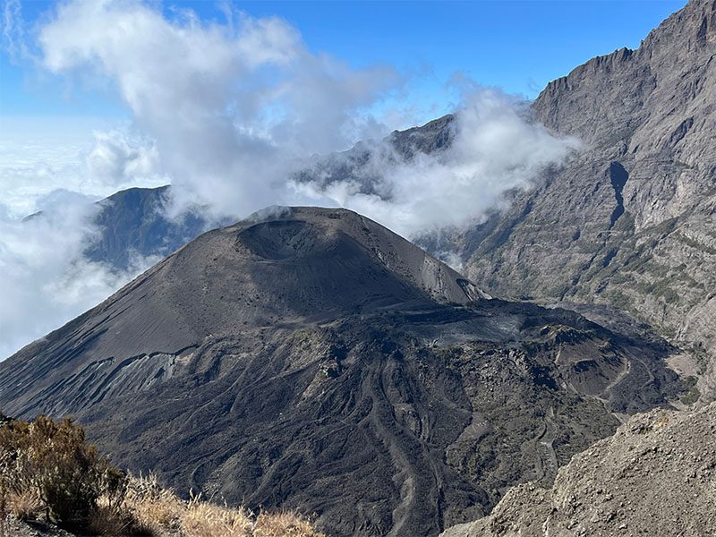 Trekkers walking along the crater rim of Mount Meru during the final ascent