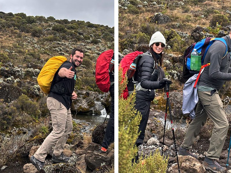 Kilimanjaro guide assisting climber with health check on trail | Kili Quests